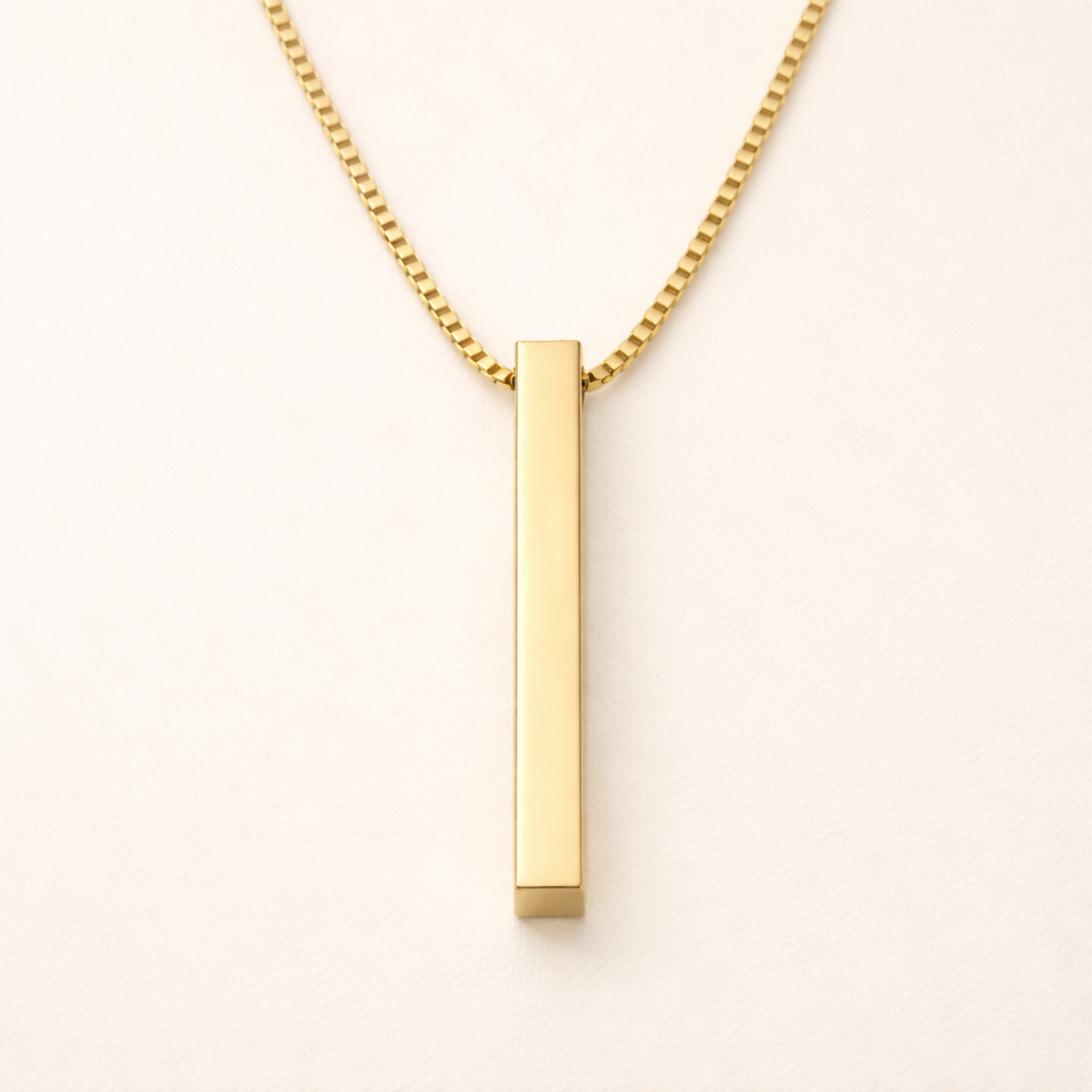 Front view of a minimalist vertical gold bar pendant on a 18k gold plated box chain