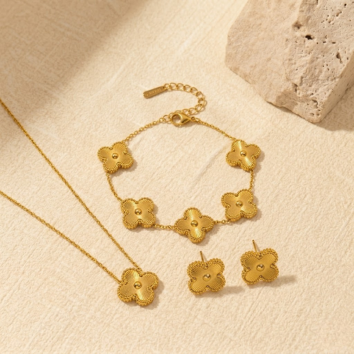 Complete vintage gold clover jewellery set featuring matching necklace bracelet and earrings by The Gift Maison
