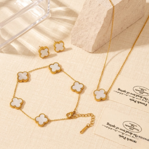 Complete luxury white clover jewelry set featuring matching necklace bracelet and earrings by The Gift Maison