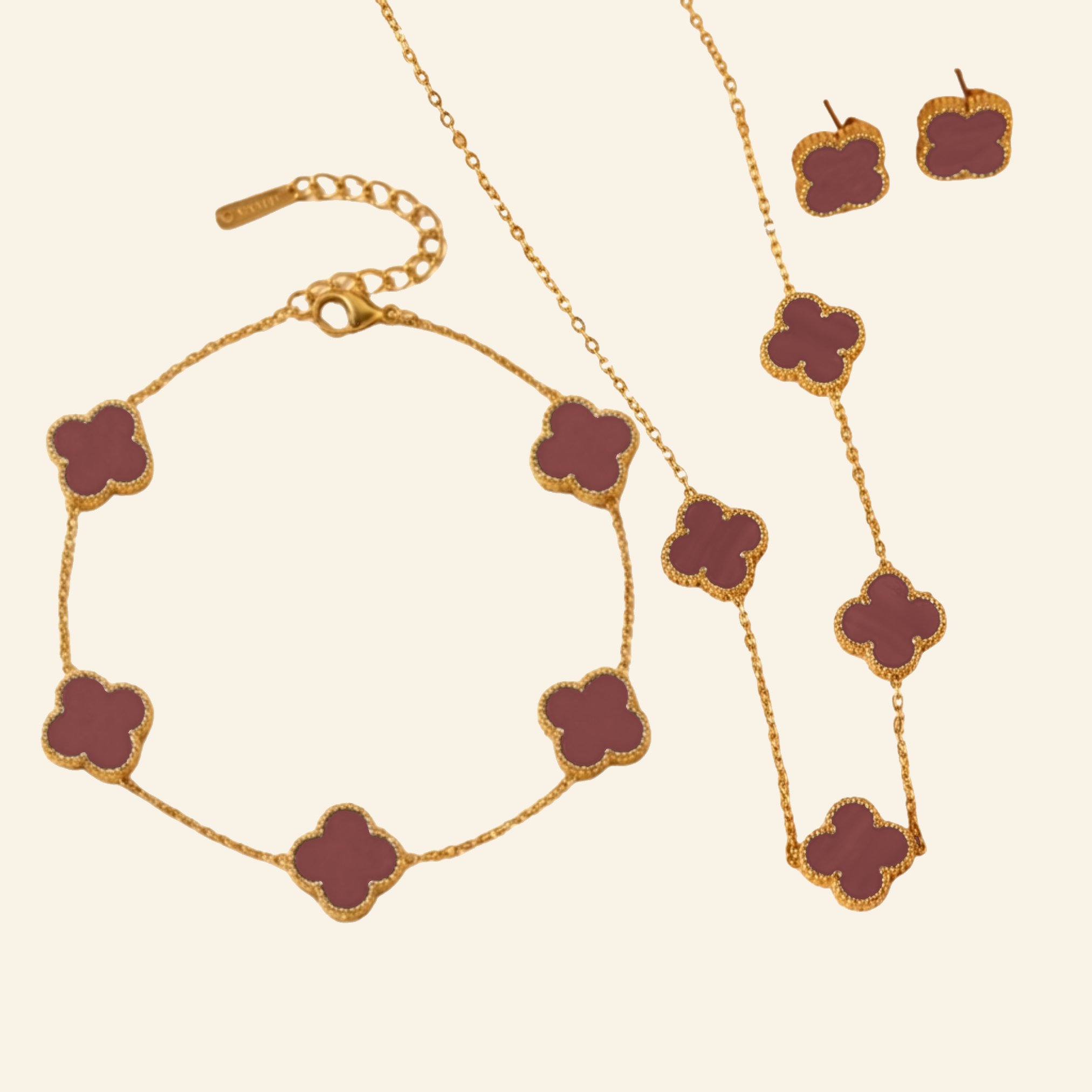 Burgundy clover jewellery set in gold: necklace, bracelet and stud earrings