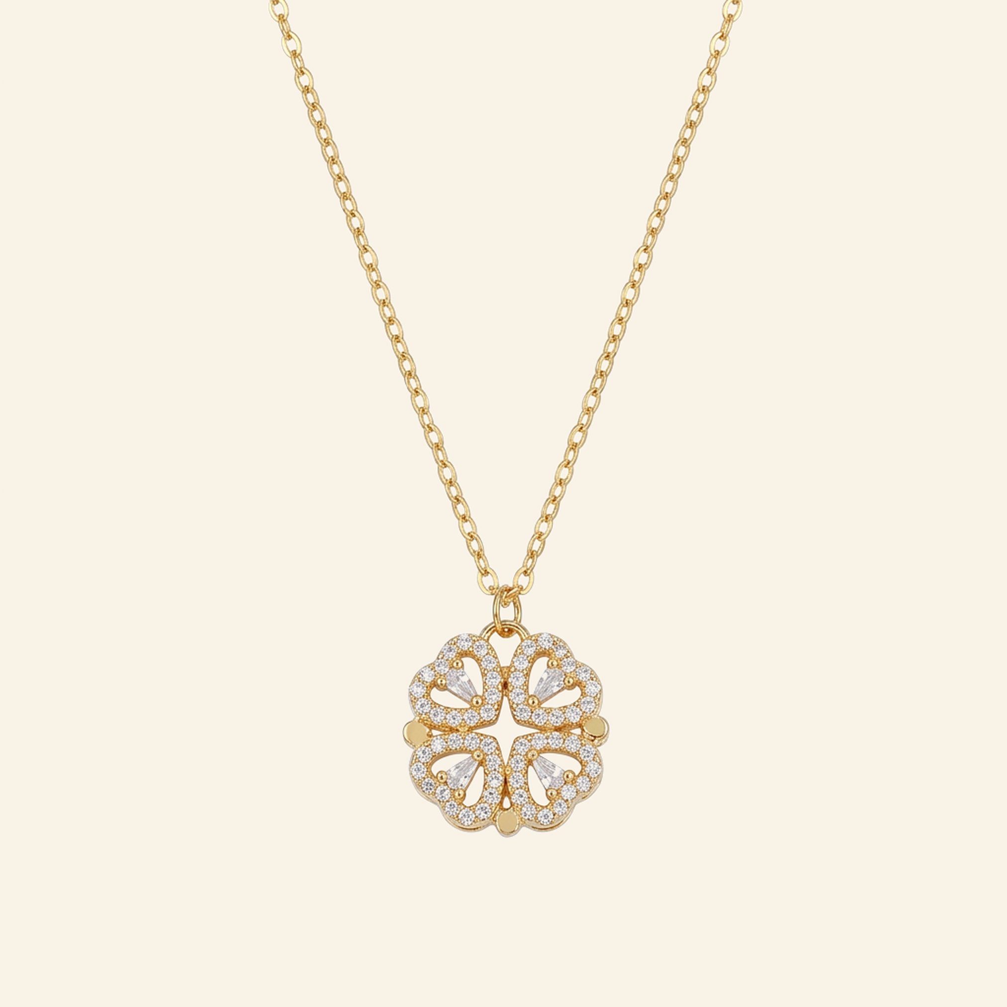 Gold four leaf clover pendant made of four crystal hearts on a fine chain