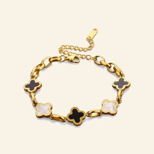 Gold chain bracelet with alternating black and white clover stations