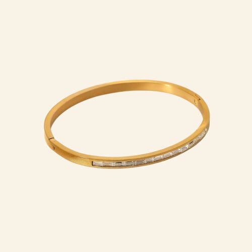 Slim 18K gold plated bangle with a row of channel-set baguette crystals