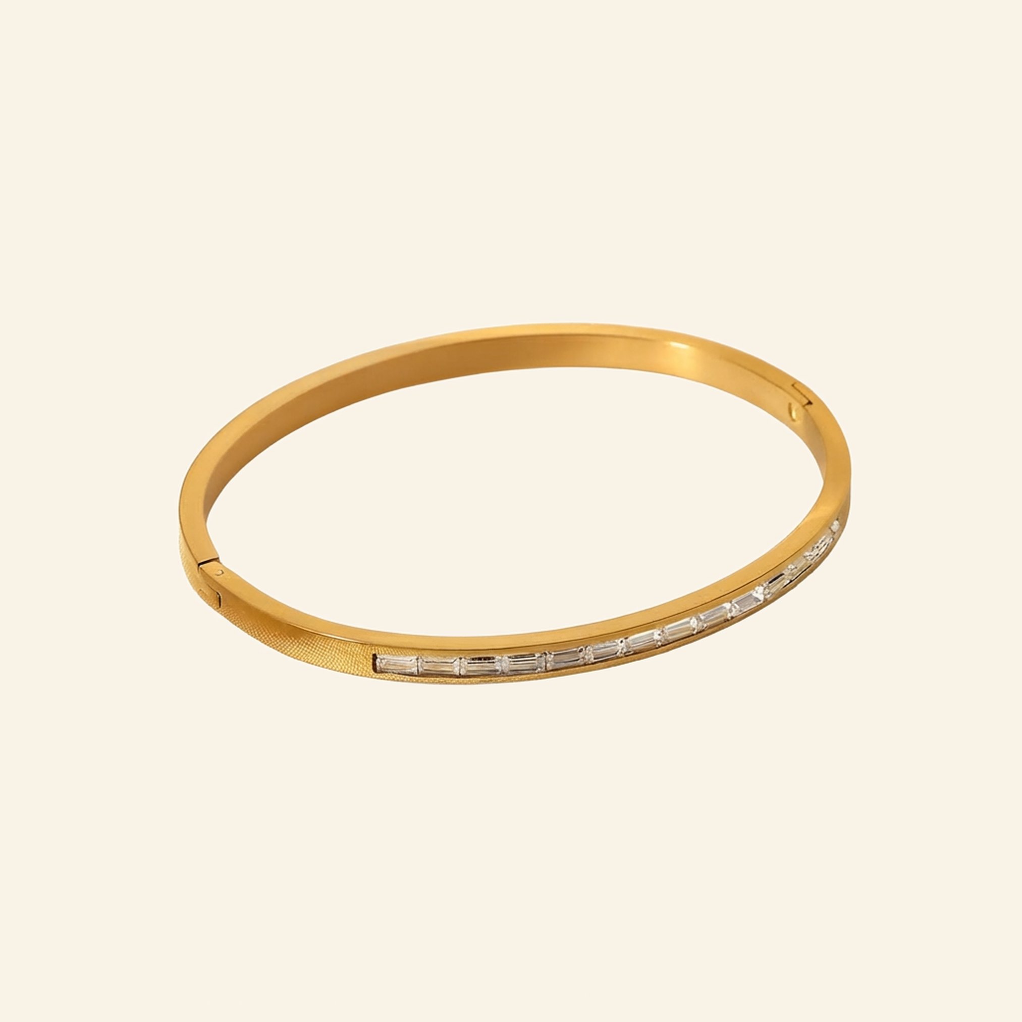 Slim 18K gold plated bangle with a row of channel-set baguette crystals
