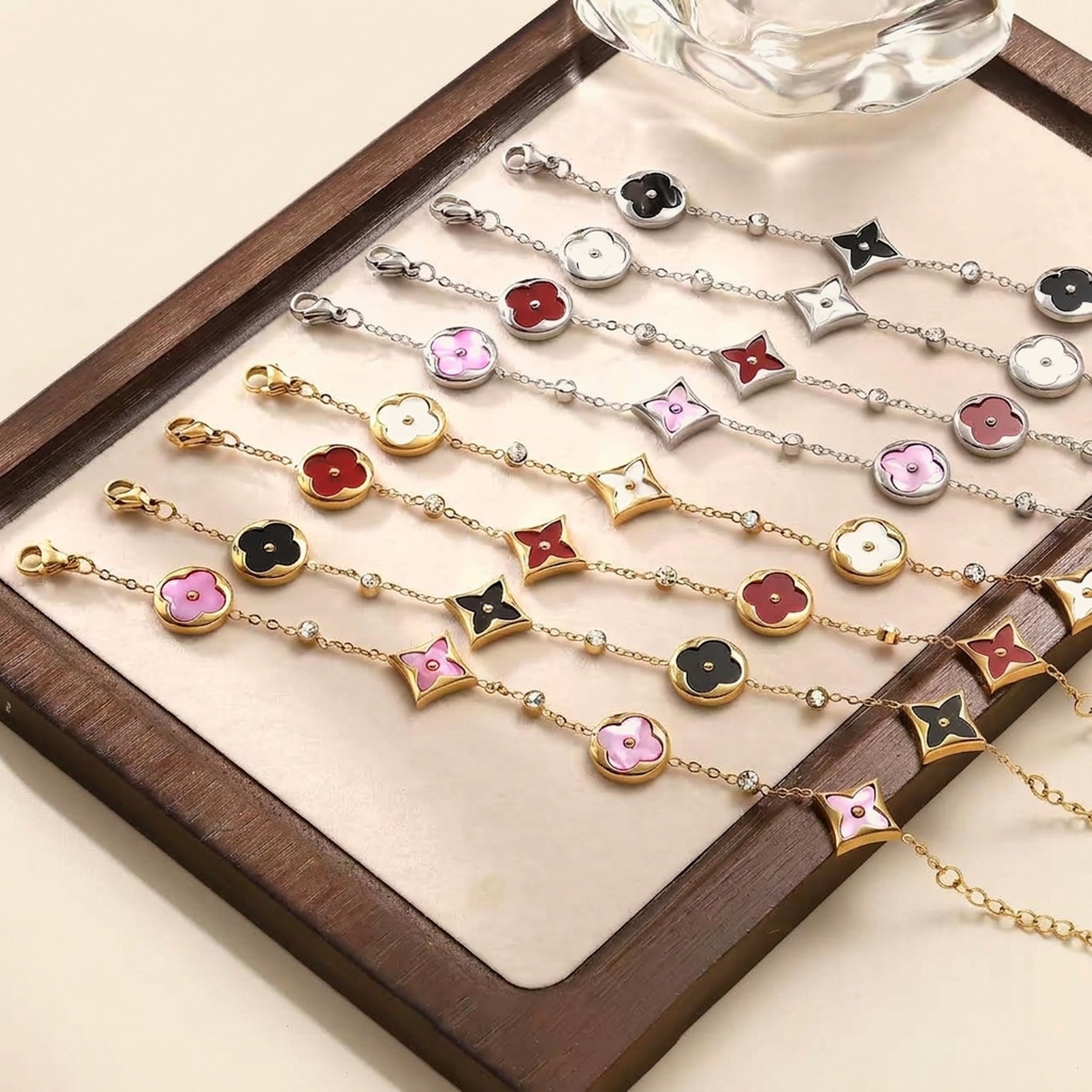 Gold flower charm bracelets in black, pink, white and burgundy