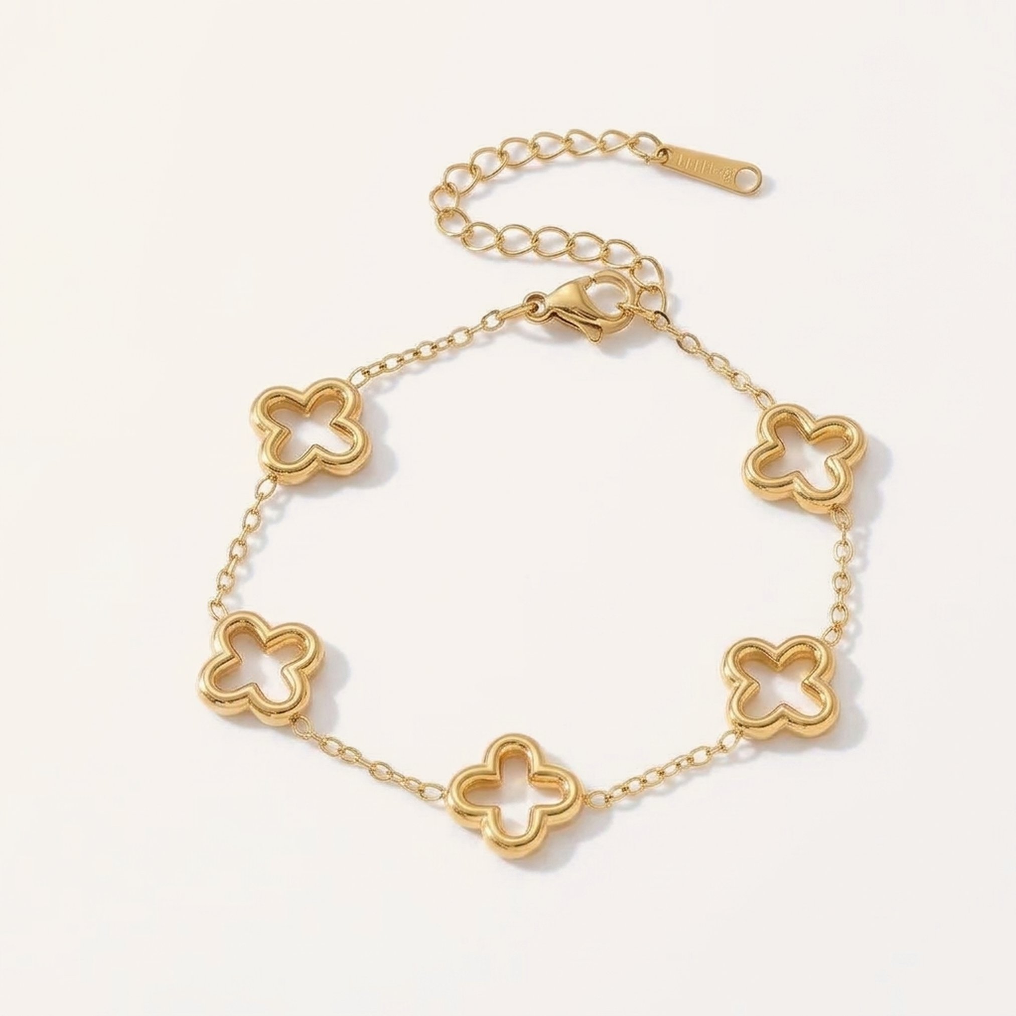 Gold bracelet with open hollow four-leaf clover stations