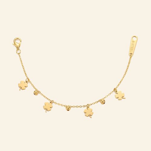 Delicate gold bracelet with tiny dangling four-leaf clover charms