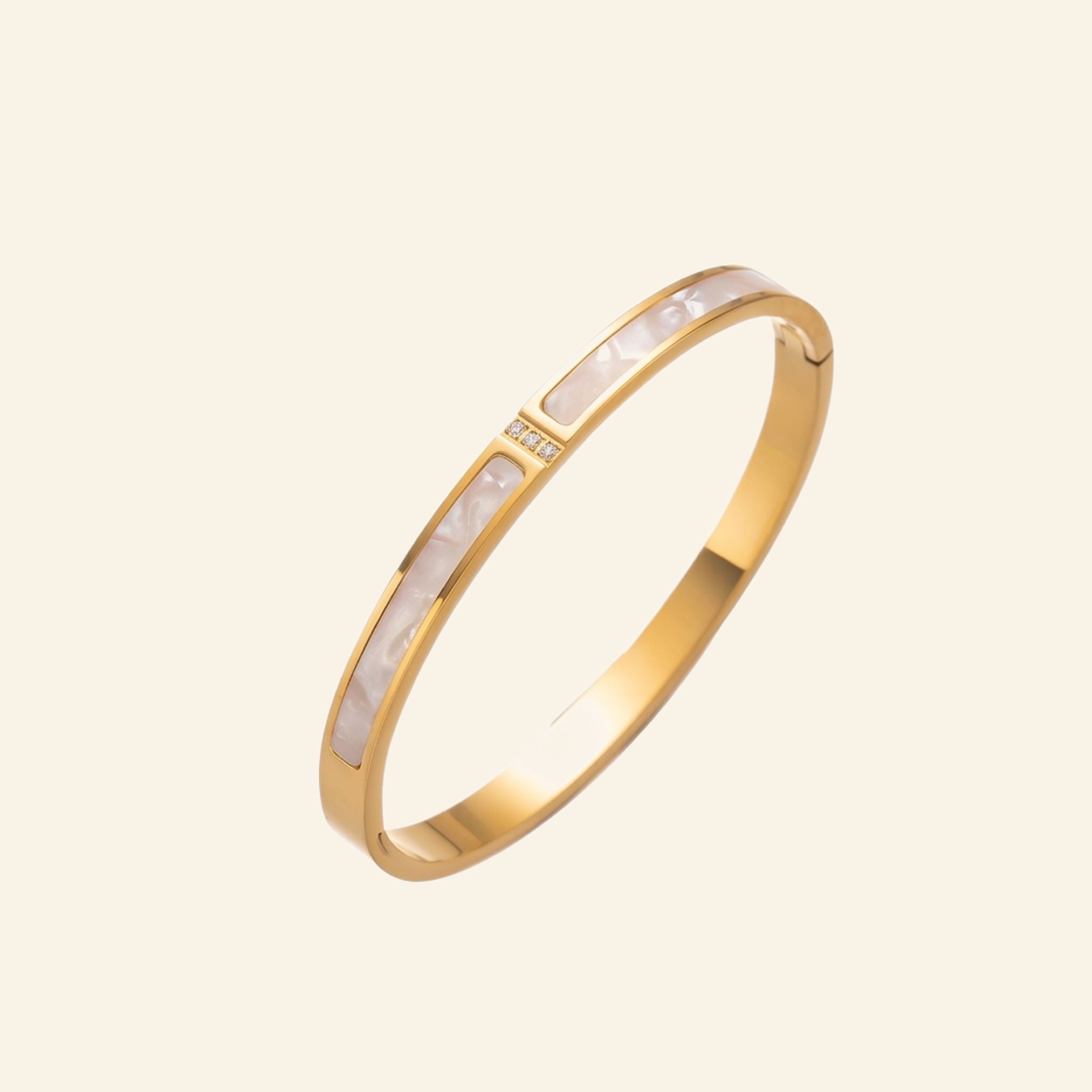 Gold bangle with an iridescent white mother of pearl style inlay and crystals
